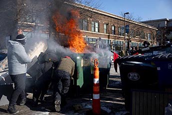 Protesters blocking traffic and lighting dumpster fires at 26th and Nicollet