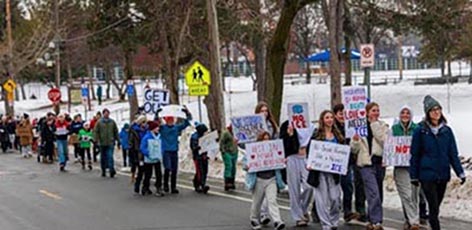 Elementary school kids marching in subzero weather near violent protests