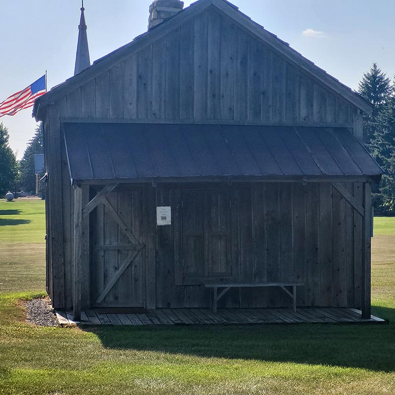 Weathered outbuilding with flag
